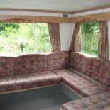 Фотография гостевого дома caravan nestled away amongst trees on edge of farm yard