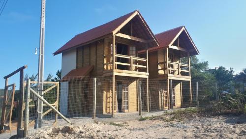 Фотография гостевого дома Chalés Rota do Sol Praia do Rosa